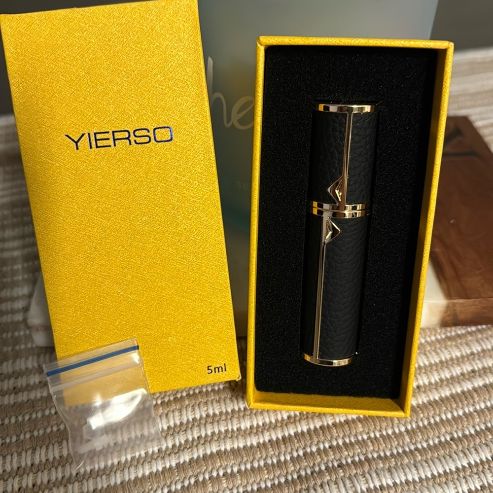 Beautiful black and gold travel perfume container